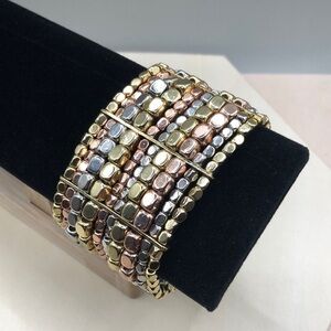 Multi tone mixed metal nugget wide pull on statement style bracelet.